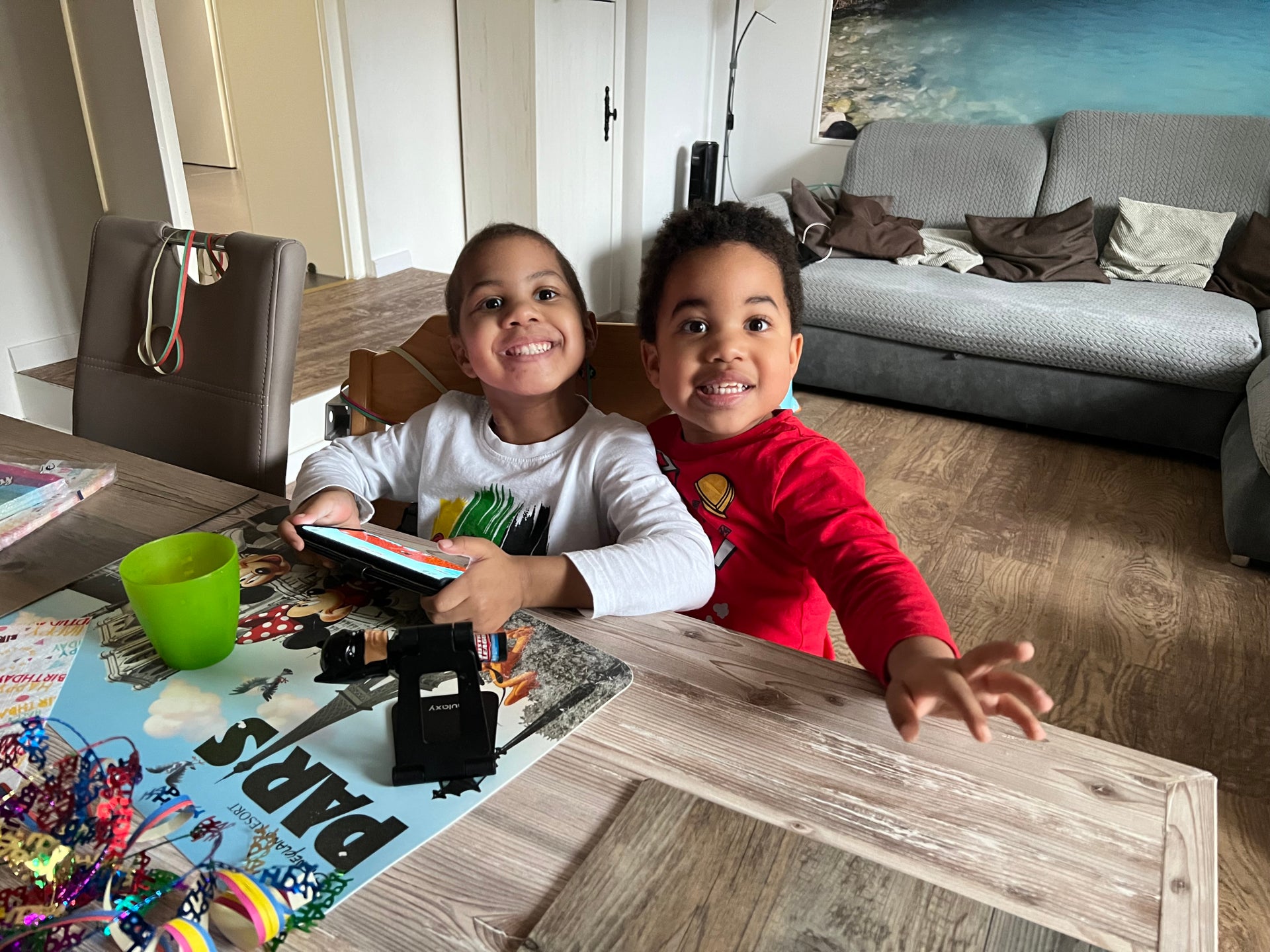 zwei kleine Kinder sitzen an einem Tisch und spielen zusammen zwei kleine Kinder sitzen an einem Tisch und spielen zusammen