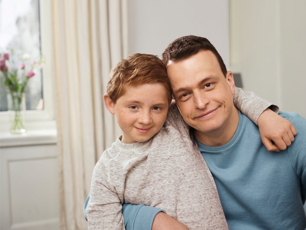 A man and boy posing for a picture A man and boy posing for a picture