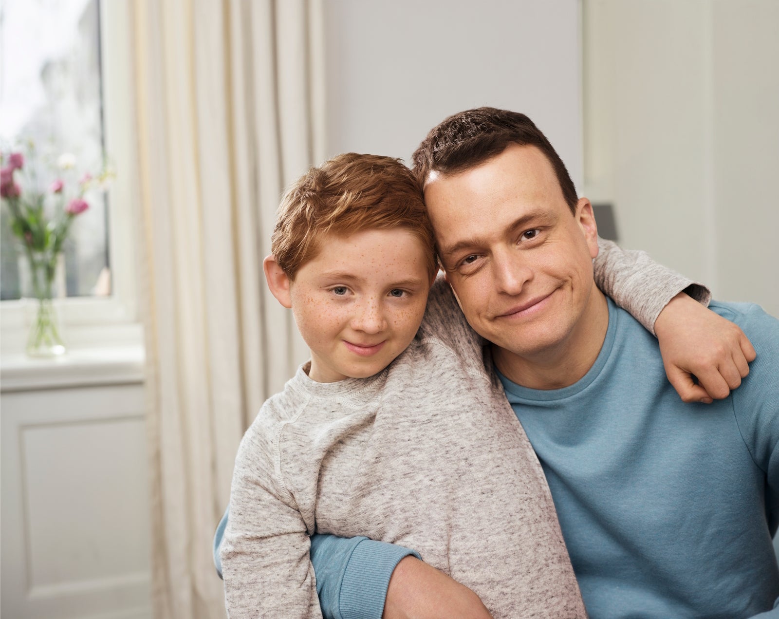 A man and boy posing for a picture A man and boy posing for a picture
