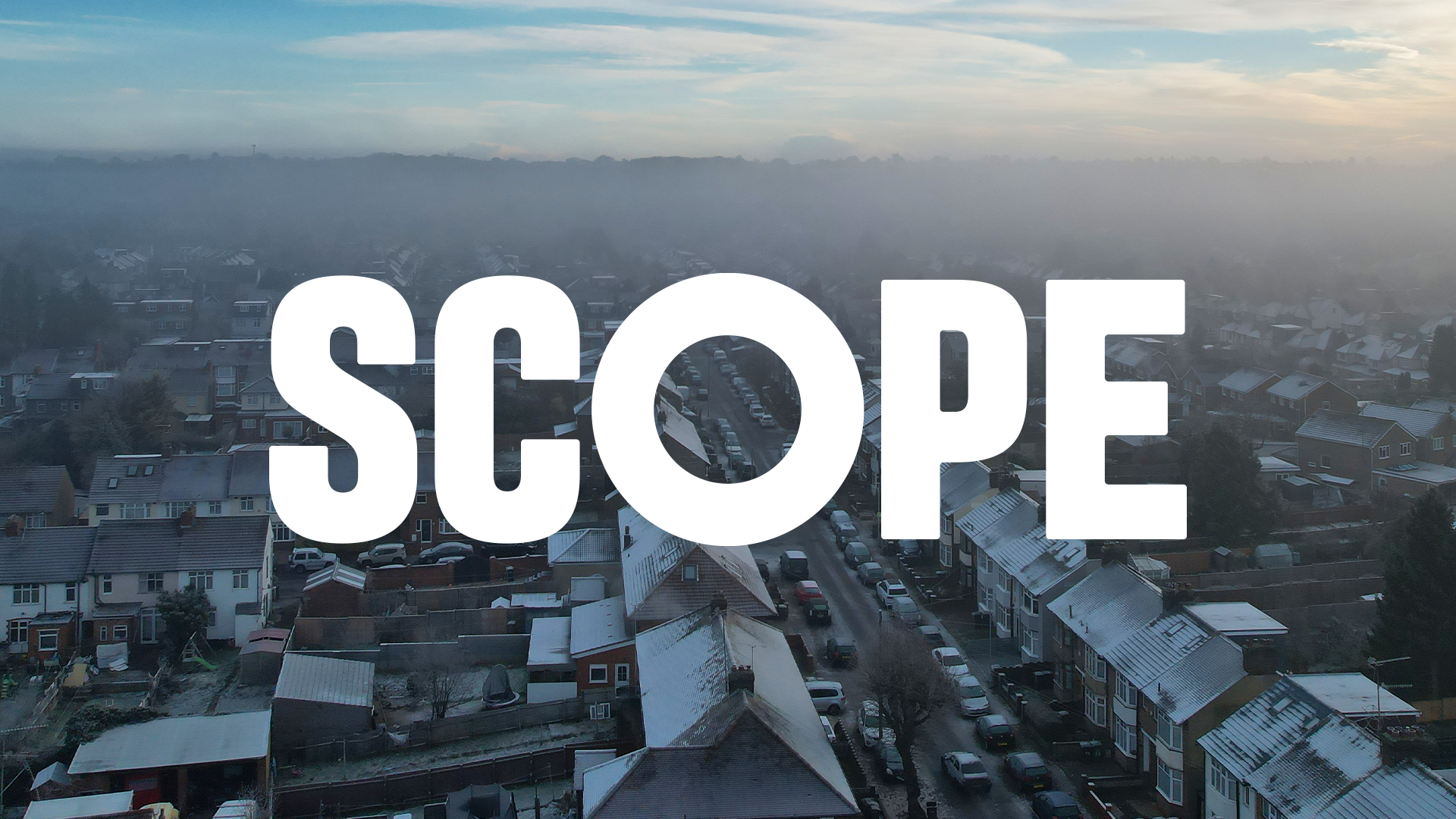 Scope's white logo on an aerial photo of houses.