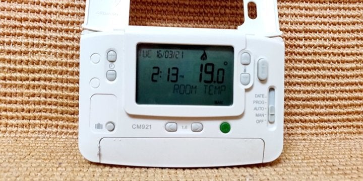 Digital thermostat for heating controls: Time adjust buttons, temperature adjust buttons and programme selector slider switch with 'date, prog, auto, man, and off' options. Display has the time, date and current temperature.