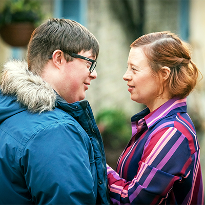 Ralph and Katie smile at each other.