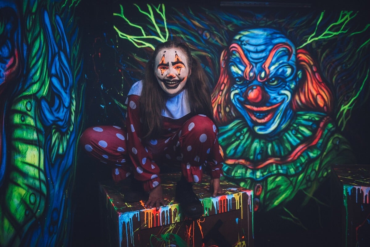 A girl dressed as a neon clown ready for FEAR