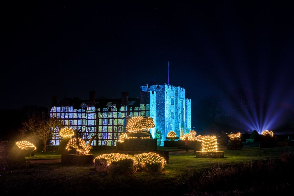 Hever Castle lit up blue in the darkness