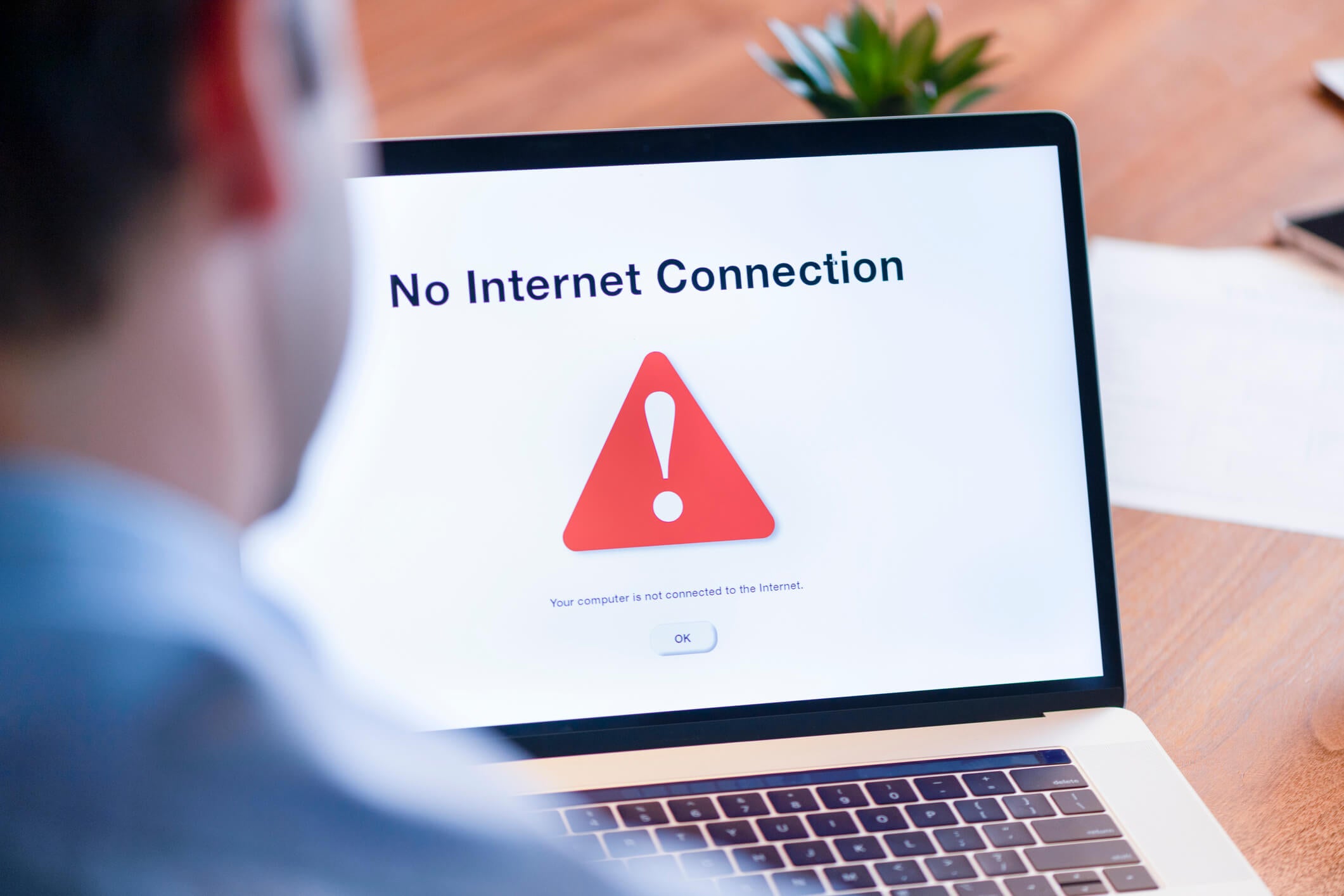 Businessman looking at an internet failure screen on a computer in an office