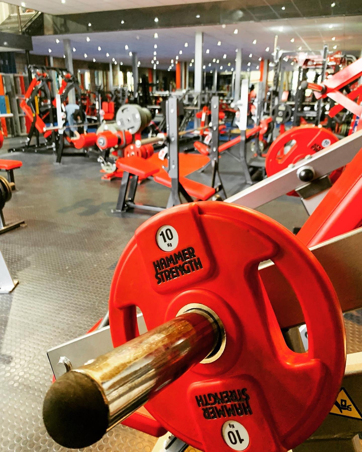 A closeup of the gym floor with their standout red gym equipment 