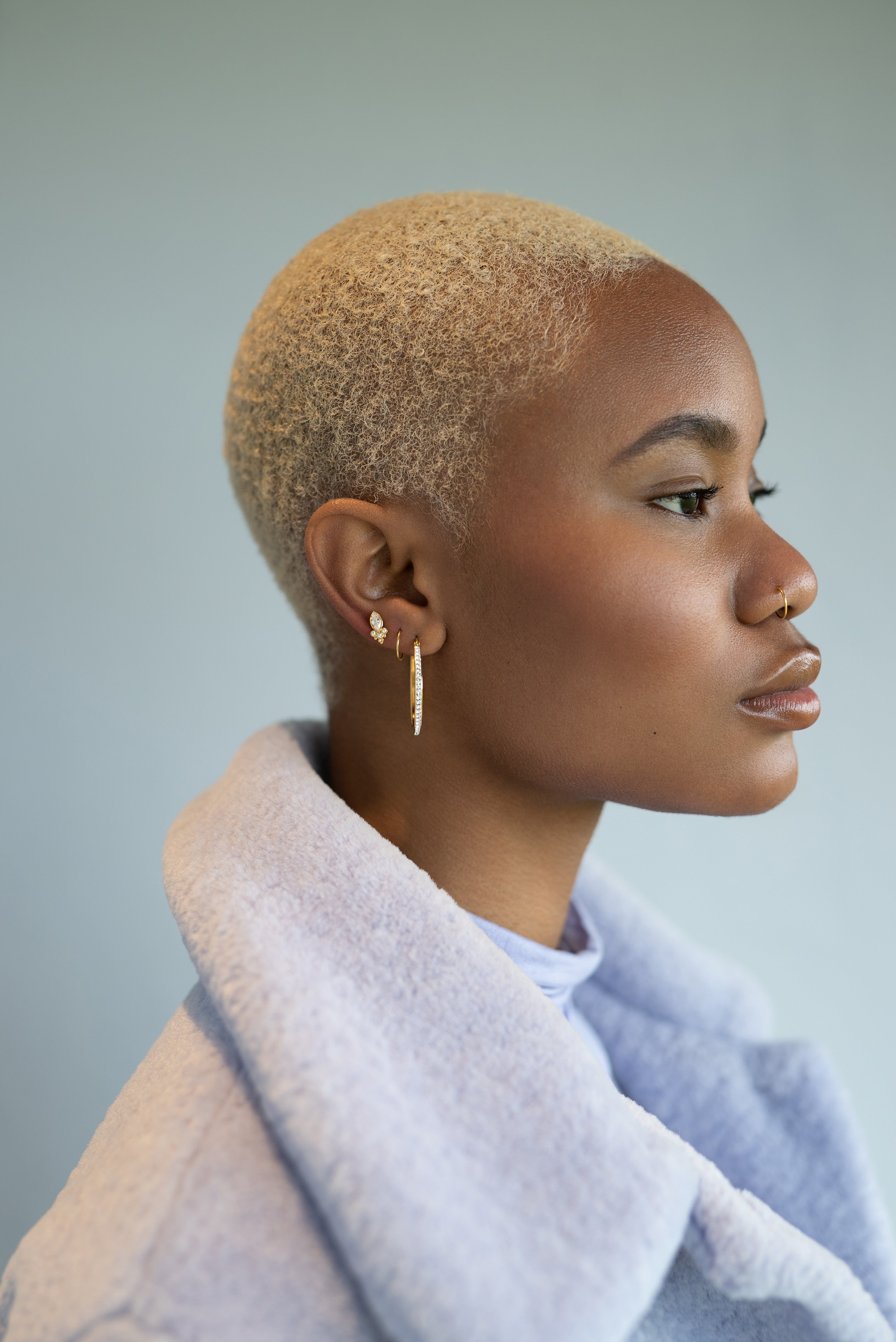 A metal morphosis model shows off her ear and nose piercings 