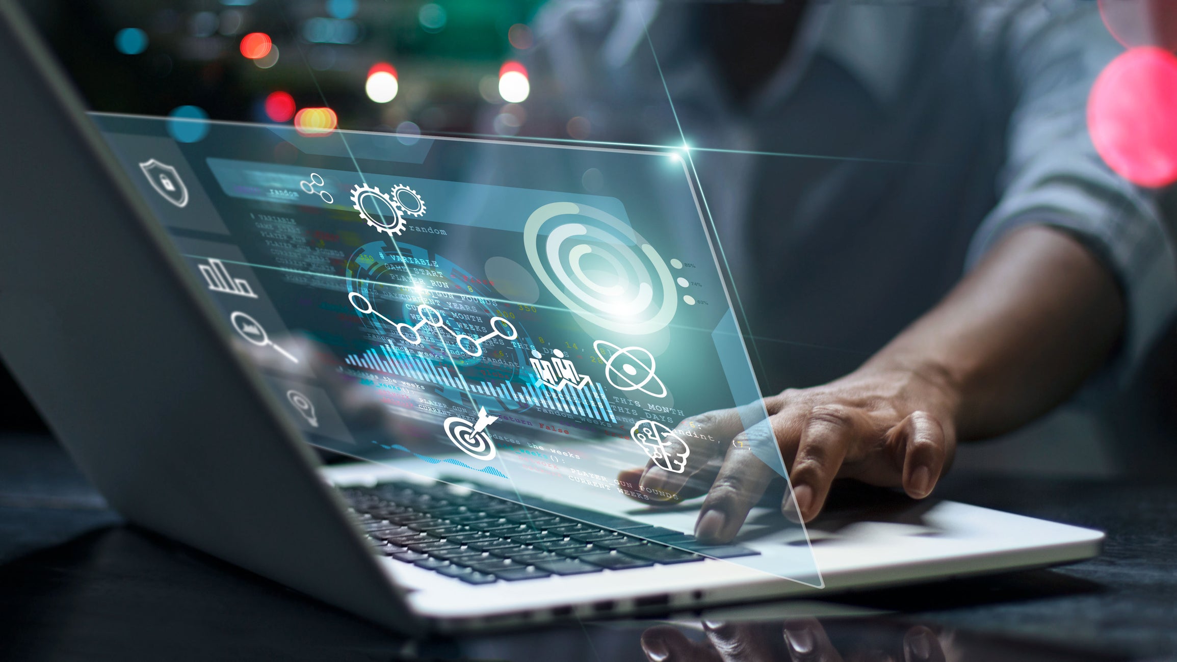A business owner sets up a network management system on a laptop