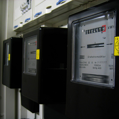 Three business energy meters with black casings and white display facing