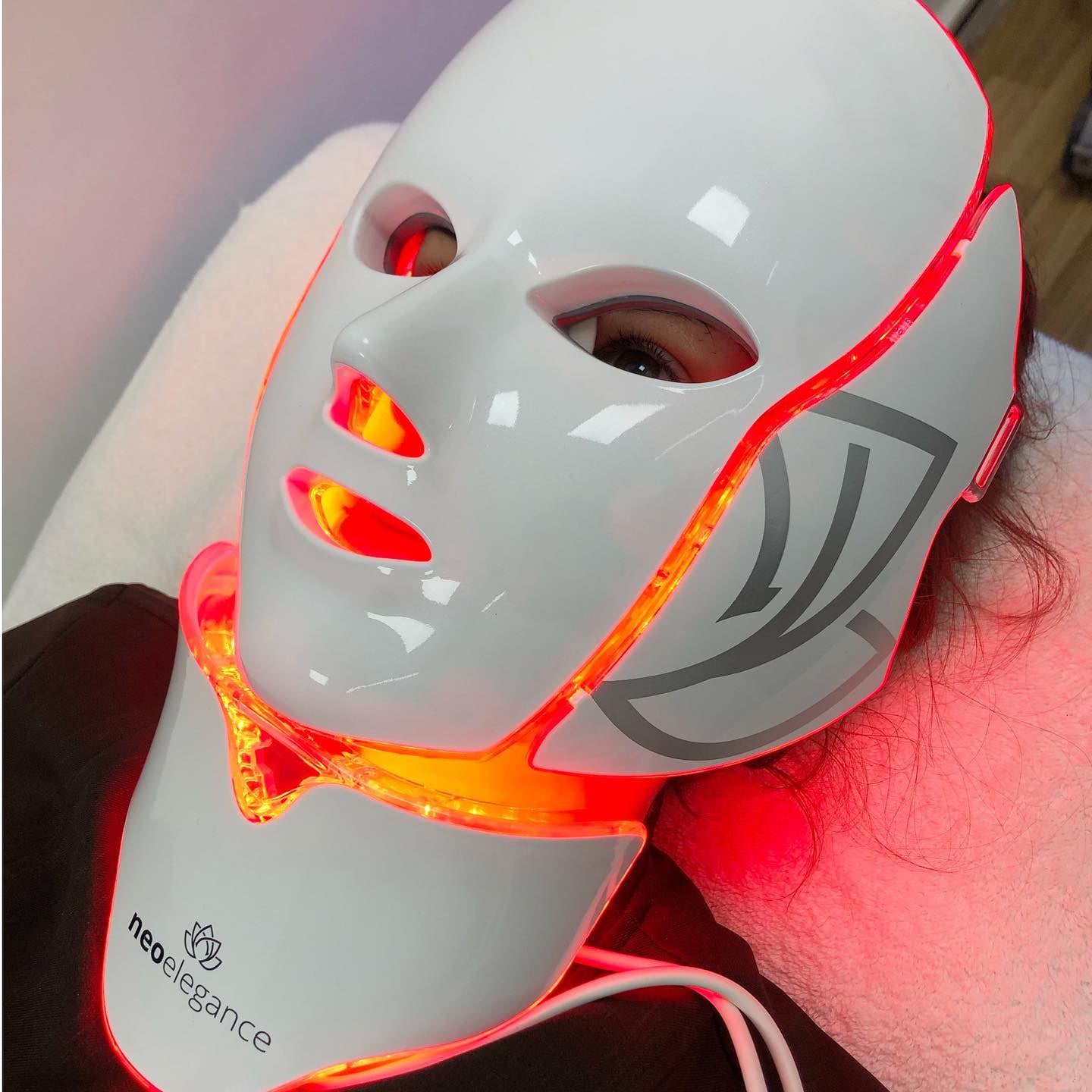 A NeoElegance customer having a face mask treatment using one of their new LED masks