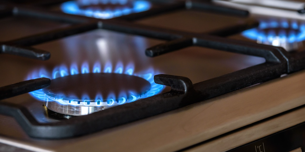 Three gas oven rings with blue flames. All business gas appliances must be Gas Safe Register checked