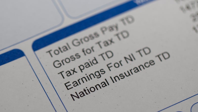 Closeup of a payslip, showing gross pay and deductions for tax and national insurance