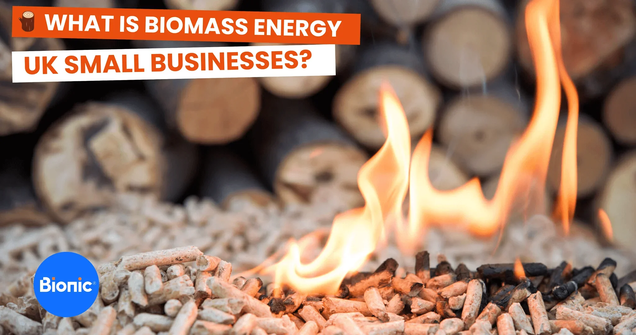 Burning wood pellets for biomass fuel in front of a pile of logs. The caption reads: What is biomass energy UK small businesses?
