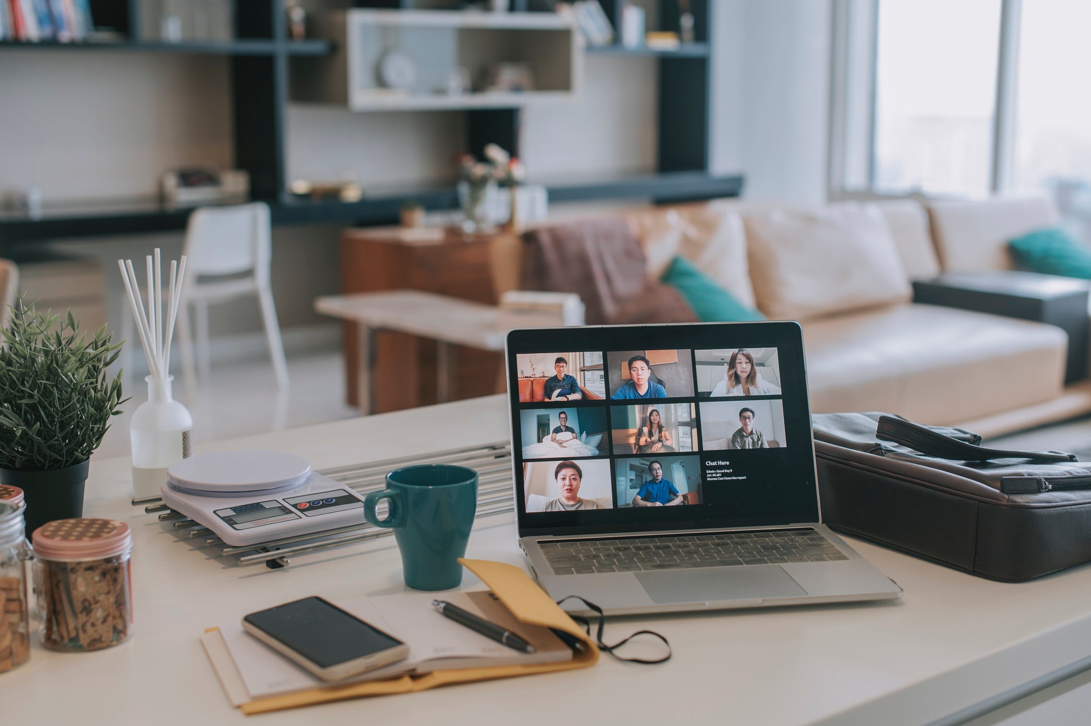 A laptop and coffee cup on the table of an employee working from home