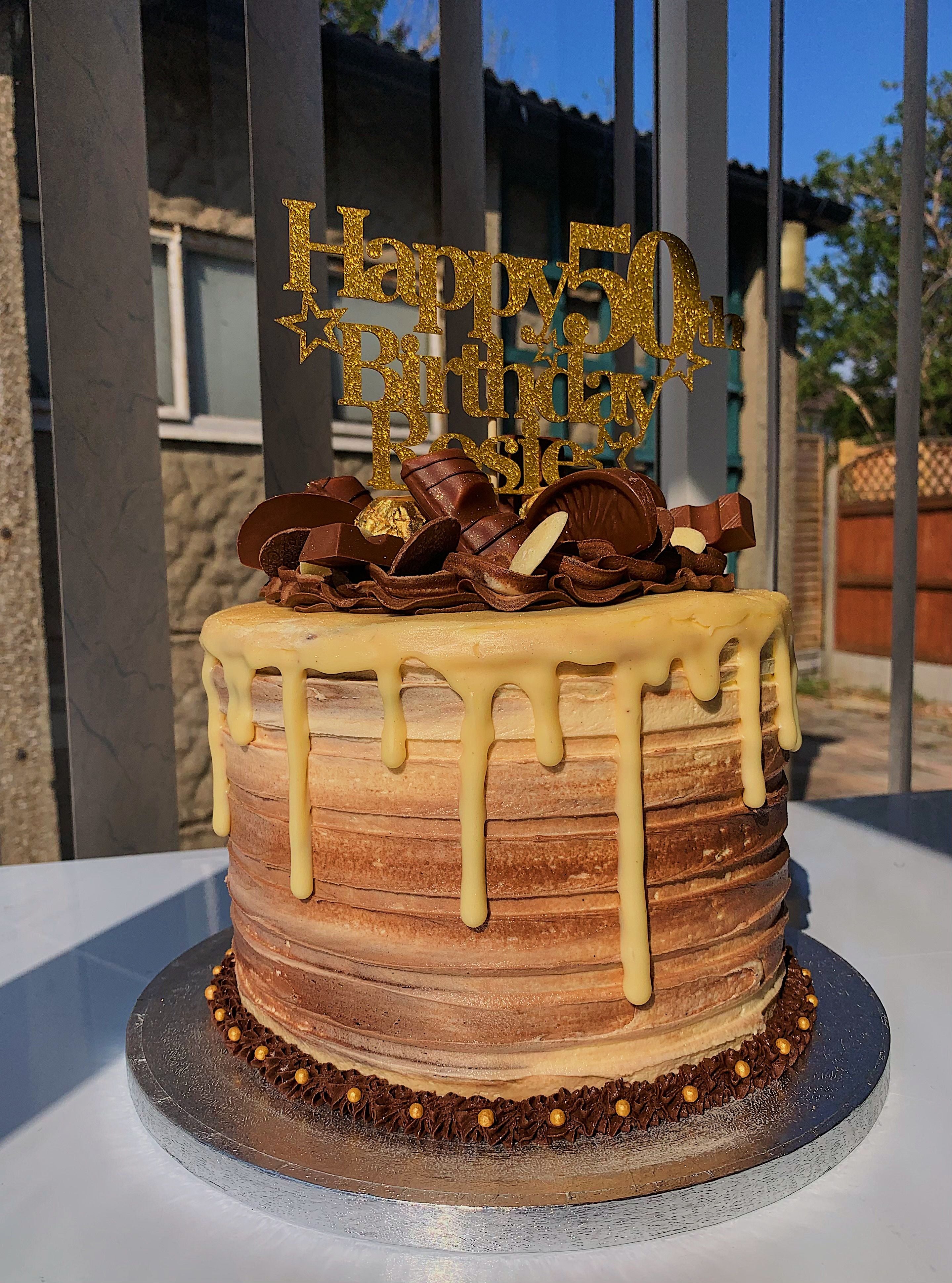 Chocolate cake decorated with Kinder and Ferrero chocolates and Happy 50th Birthday on top