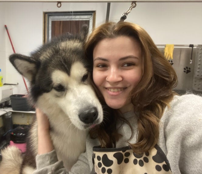 Ella with one of her clients, a fluffy husky 