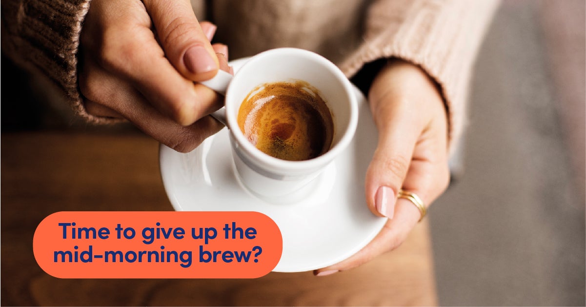 Woman holds a white cup containing a single espresso coffee