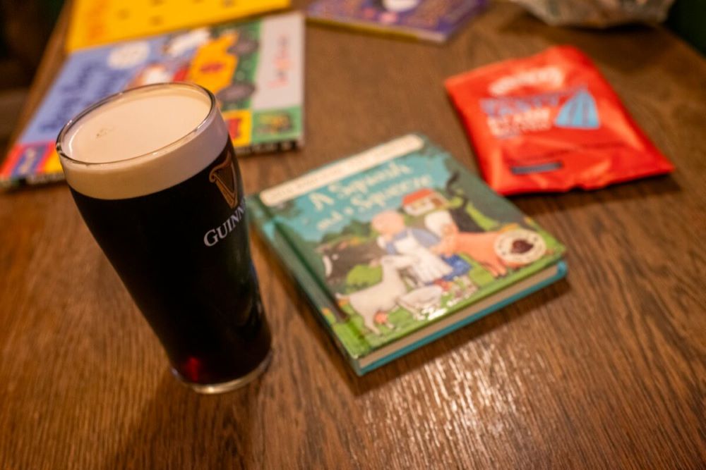 A pint of Guinness next to a children's picture book. Photo by Josh Bright.