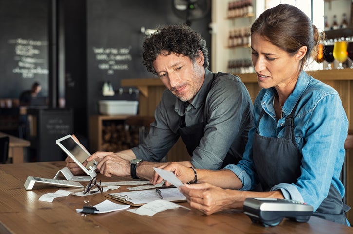 A couple of business owners work out costs as their cafe is affected by the cost of living crisis.