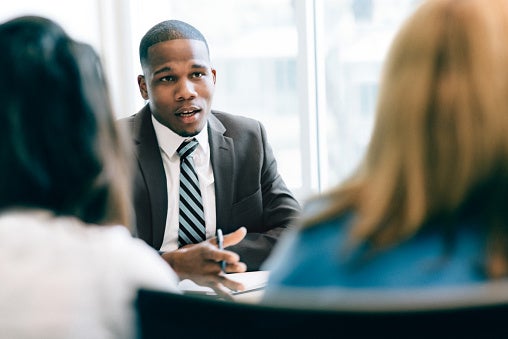 A bank manager arranges a business bank account with two business owners