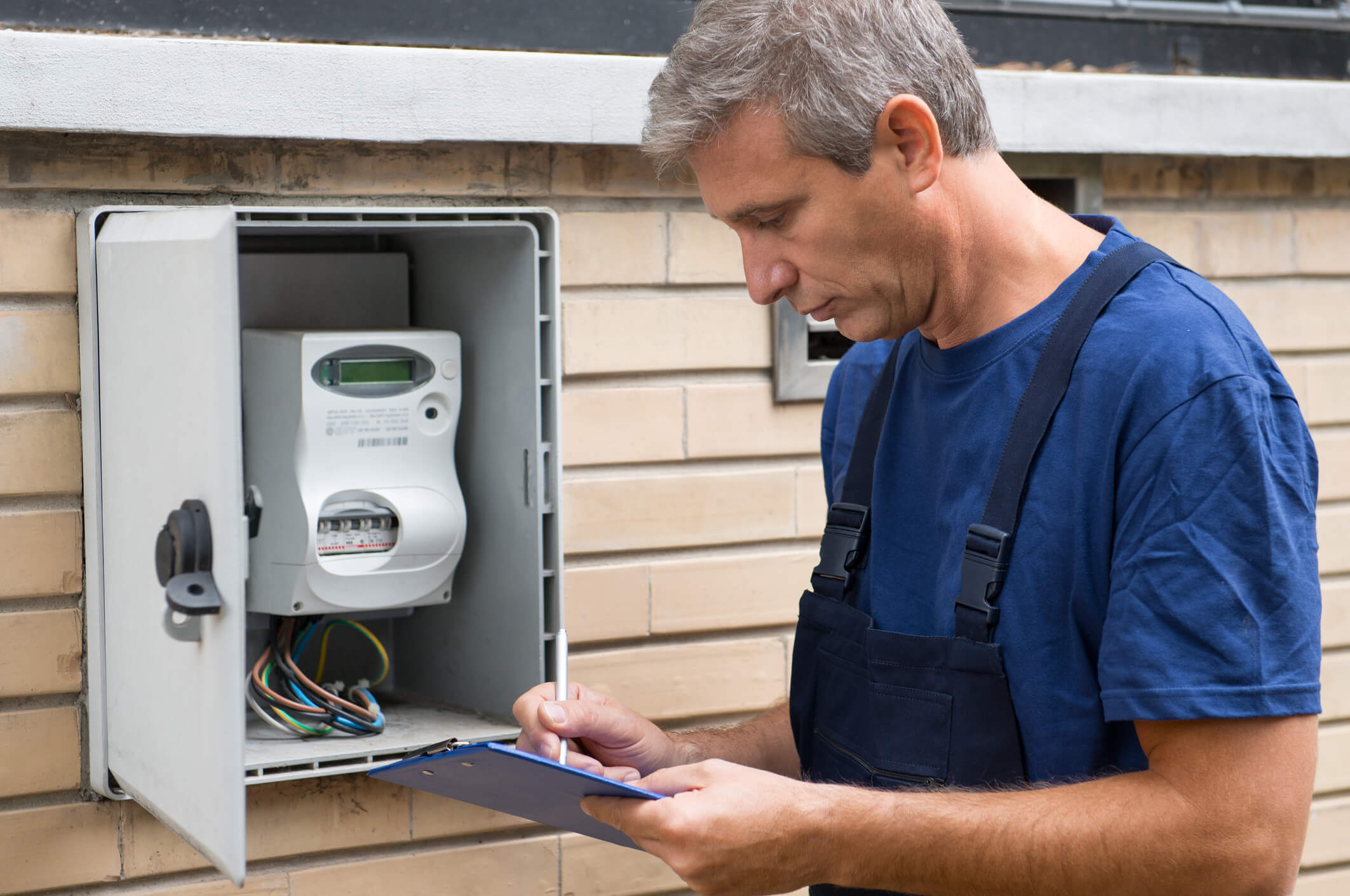 An engineer takes an electricity meter reading. The standing charge on an energy bill covers the cost of this service.