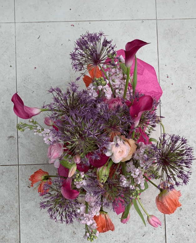 A floral arrangement of pink, purple, and orange flowers from Filth Florist