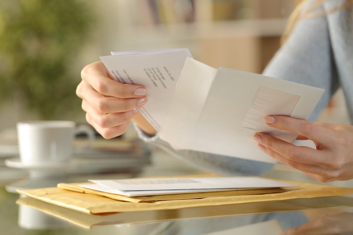 A business owner opens a letter that's been sent to their new business address