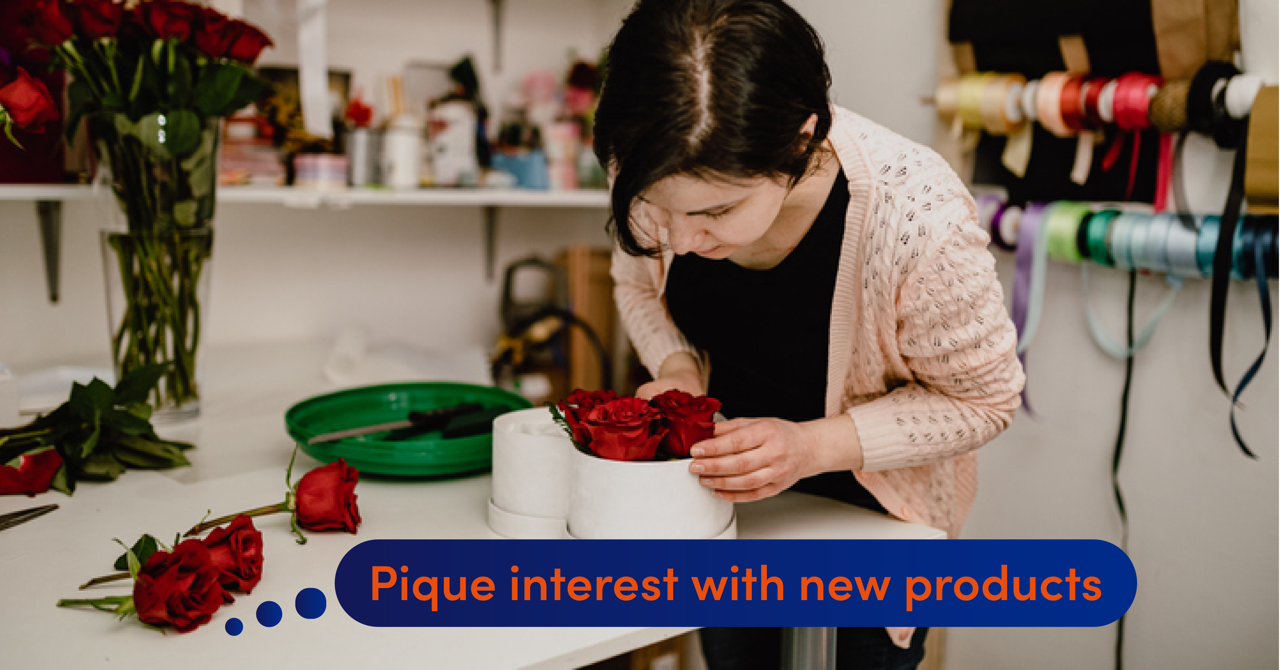 A florist cuts roses and puts them into a white box.