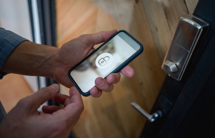 male holding smartphone with locked wifi