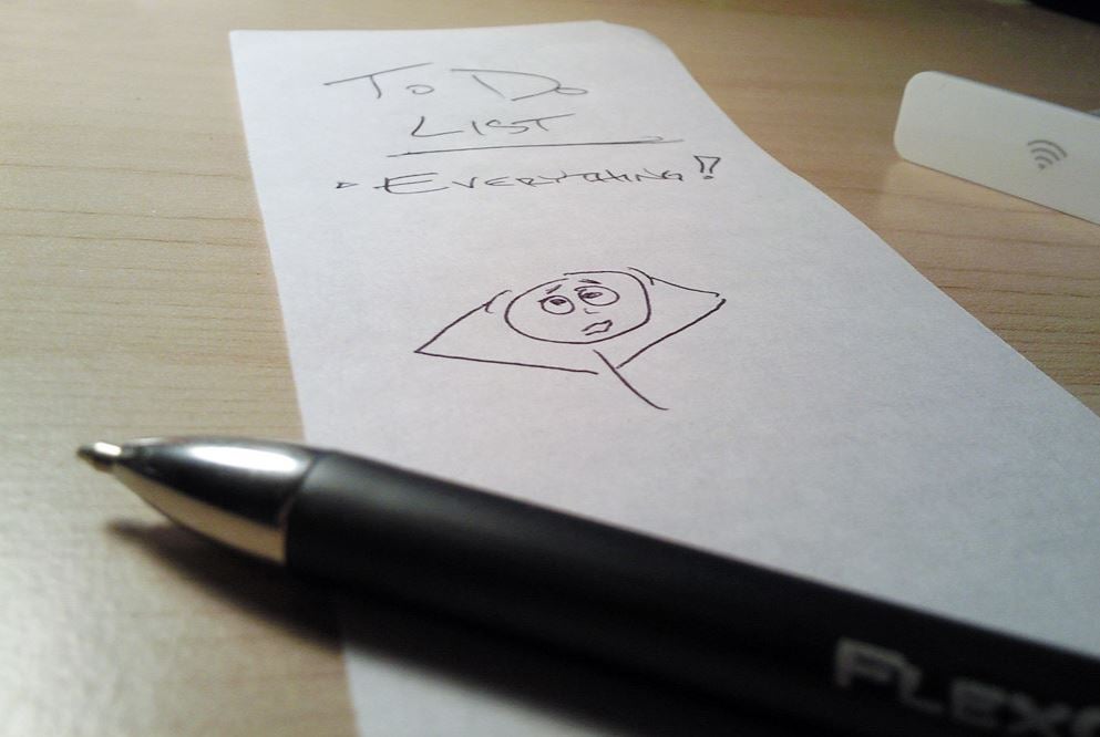 Black pen next to white paper. On it is written 'to-do list. Everything' and drawing of worried stick man.