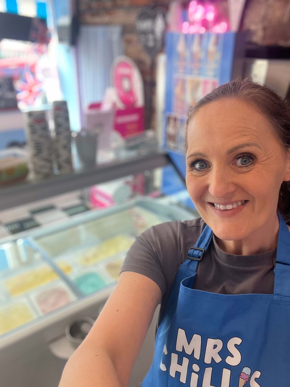 Corrie smiling in front of her ice cream selection 