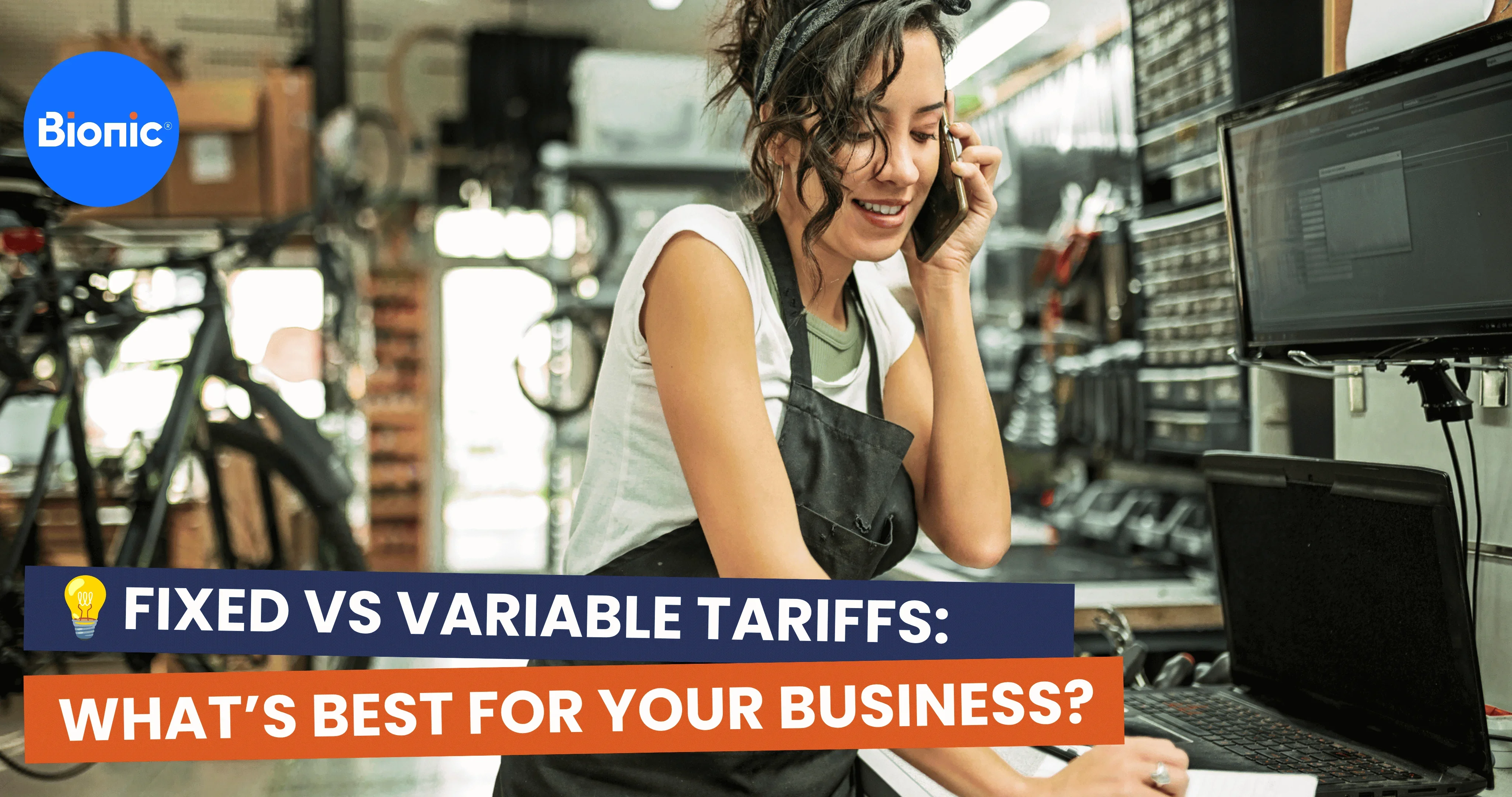 Person working in a workshop or retail business speaks on a mobile phone while using a laptop, alongside the headline “Fixed vs Variable Tariffs: What’s Best for Your Business?” and the Bionic logo.