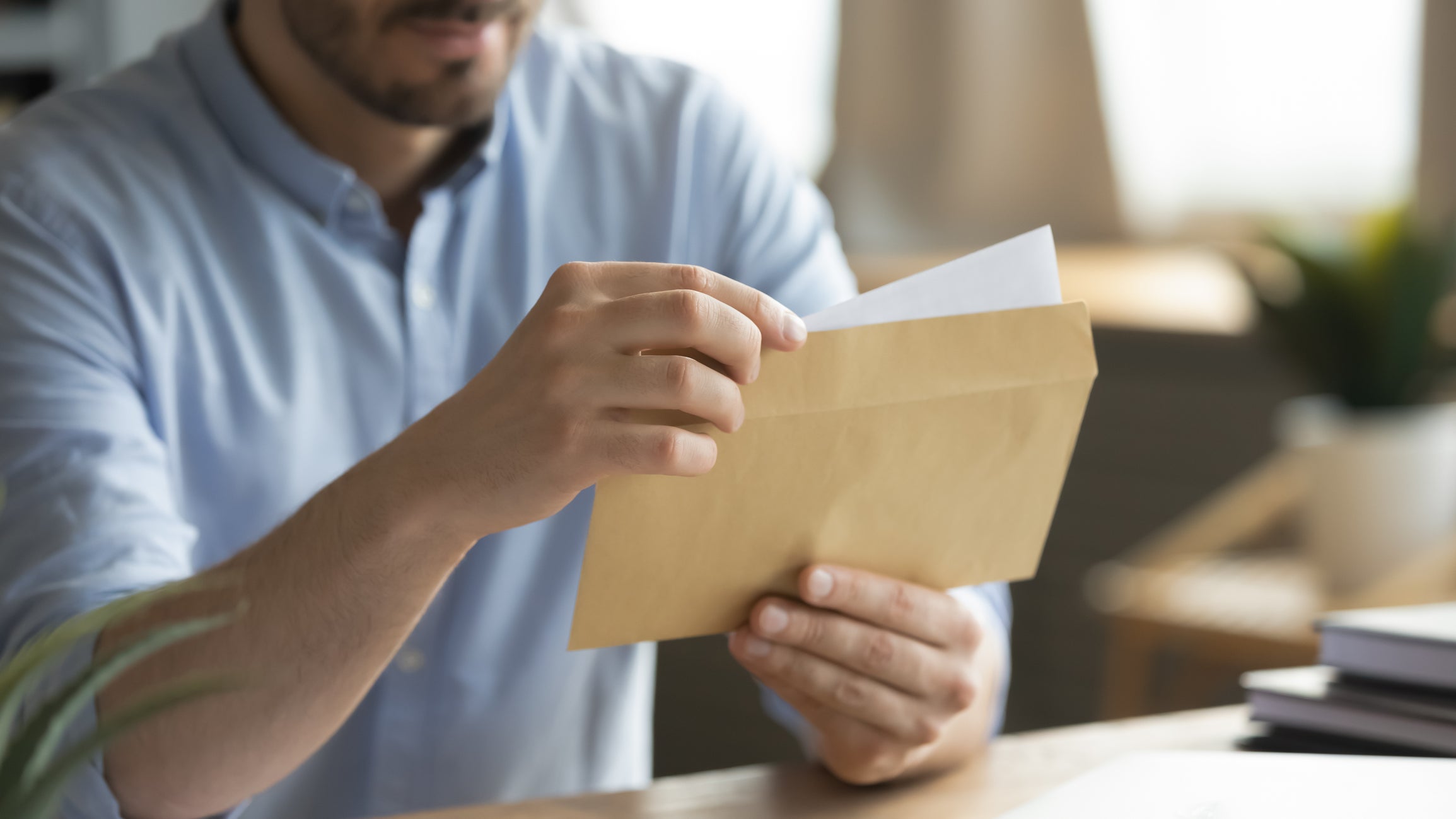 A business owner looks through his invoices while working out his businesses energy bills