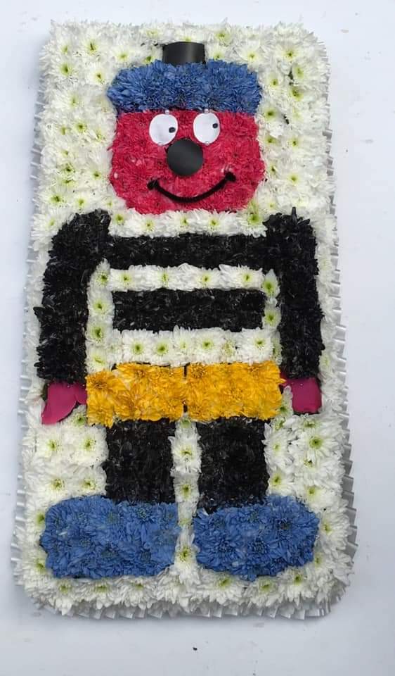 Foral arrangement in the shape of Bertie Bassett