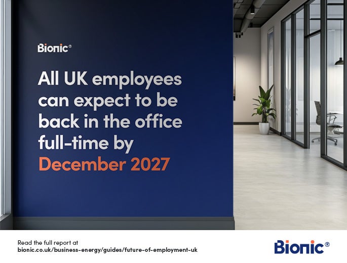 A blue wall in an office with white text explaining that "All UK employees can expect to be back in the office full-time by 2027"
