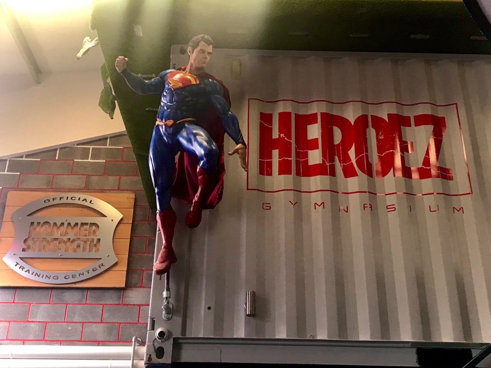 A lifesized figure of Superman keeps watch over Heroez gym