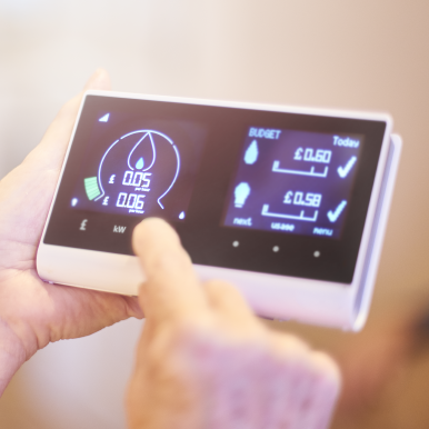 Hands holding a smart meter for business energy