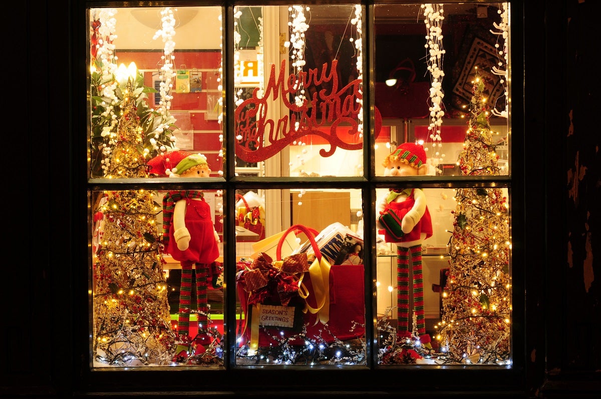 A Christmassy shop front with lights and tinsel 