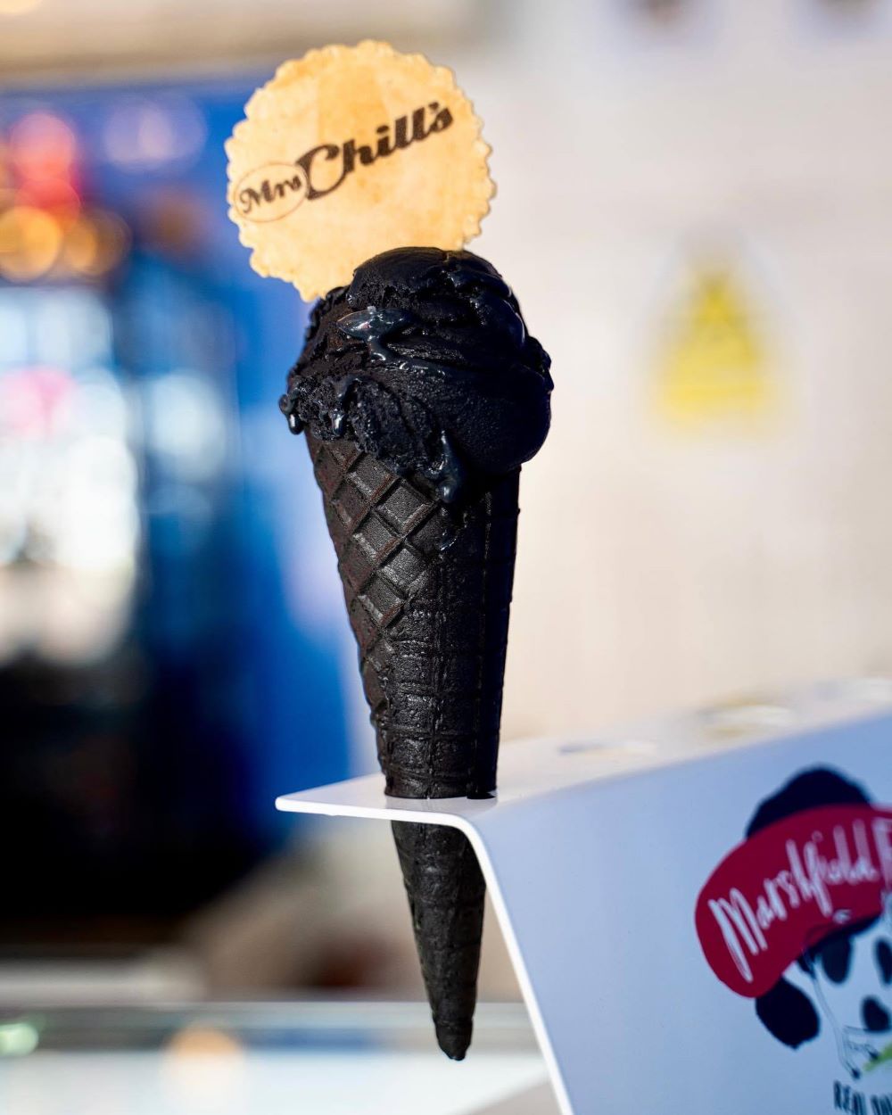 A black ice cream in a black cone