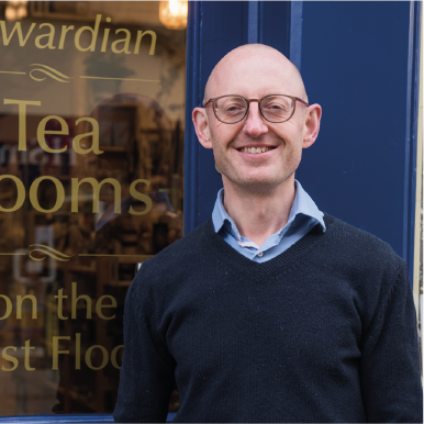 Martin Coles Evans stands outside his shop