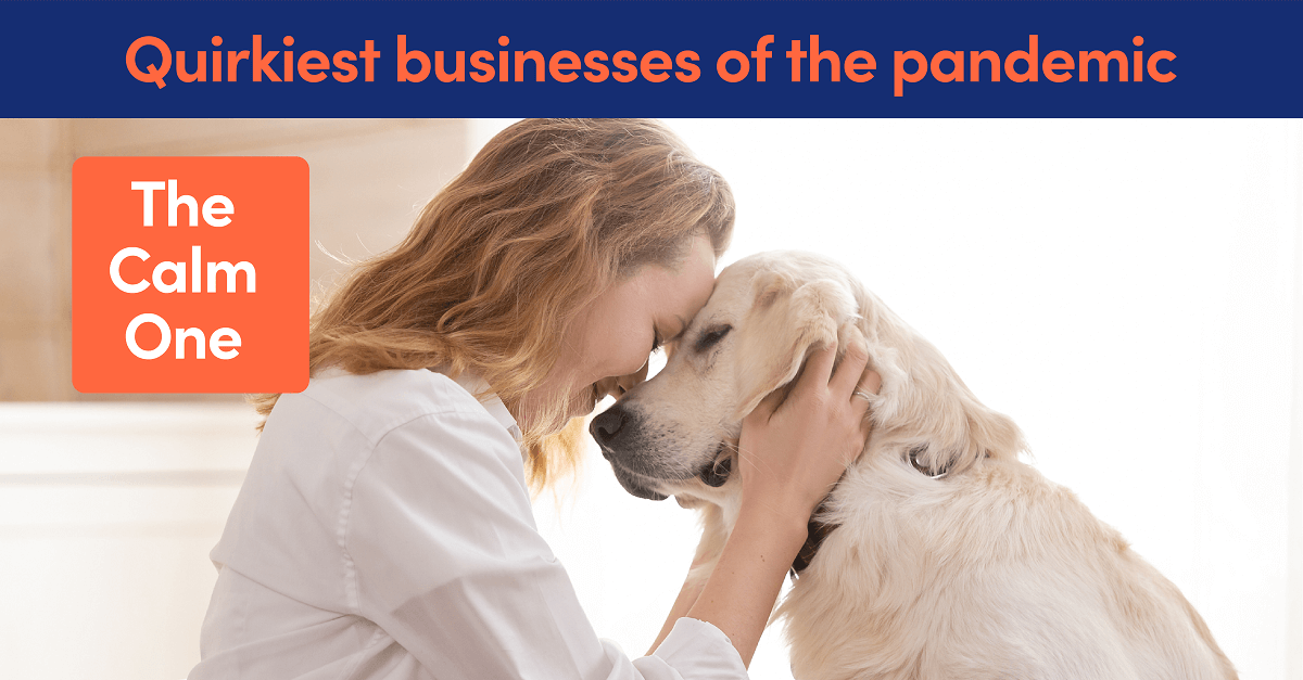 A woman cuddling a golden retriever dog