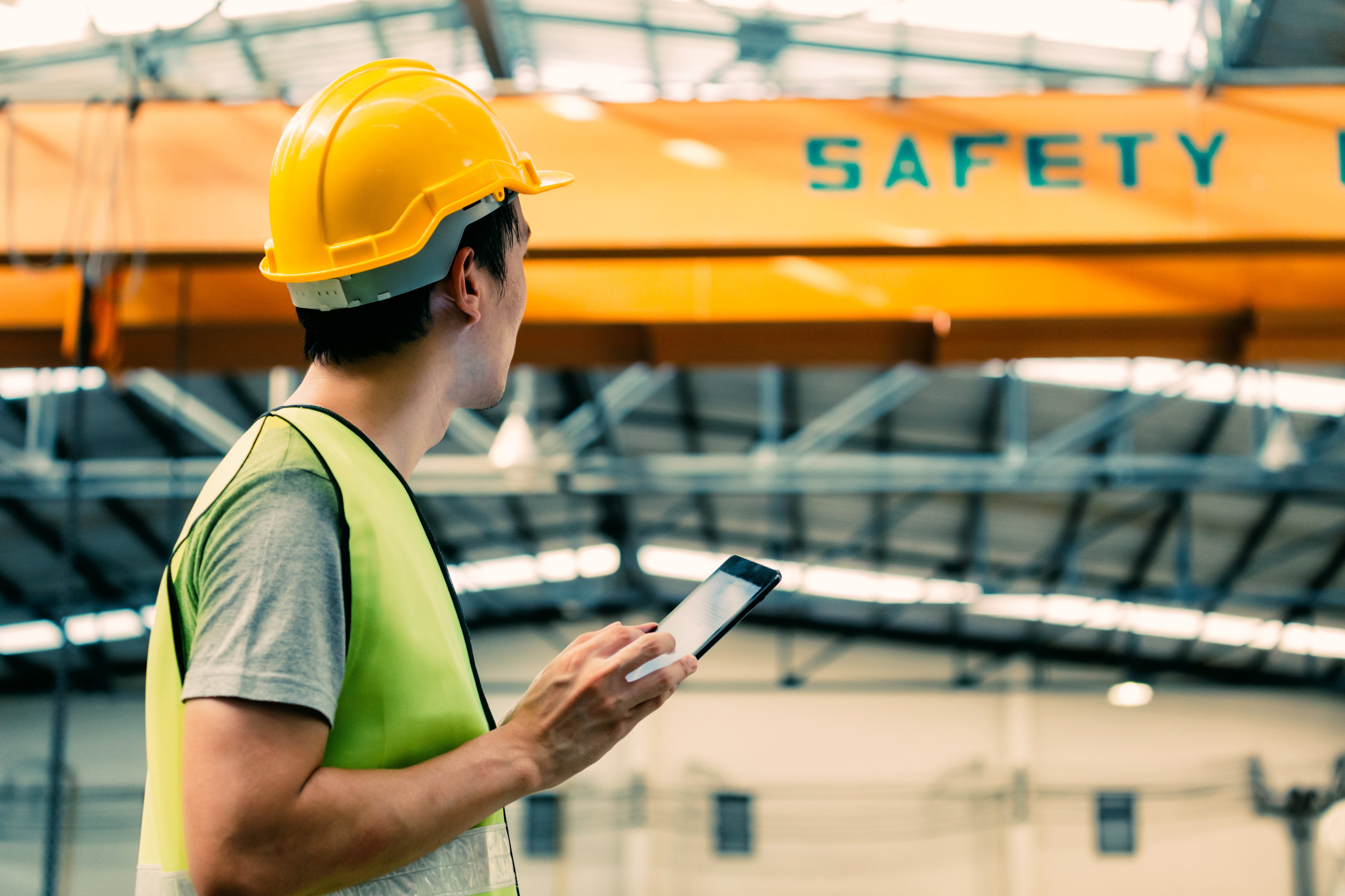 A man in a hard hat inspects his workplace 