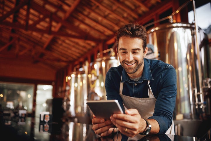 A SME owner browsing eCommerce platforms on a tablet