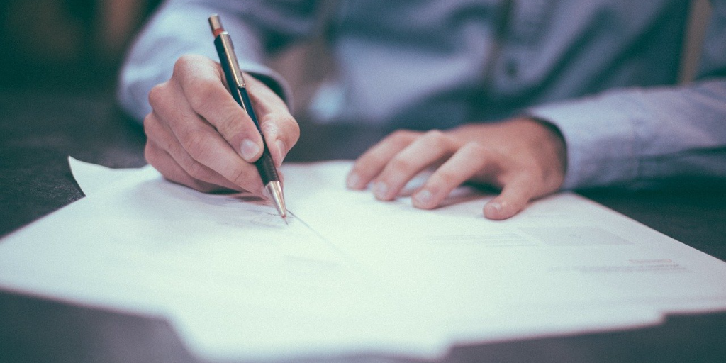 Man signing a letter of authority to switch business energy supplier