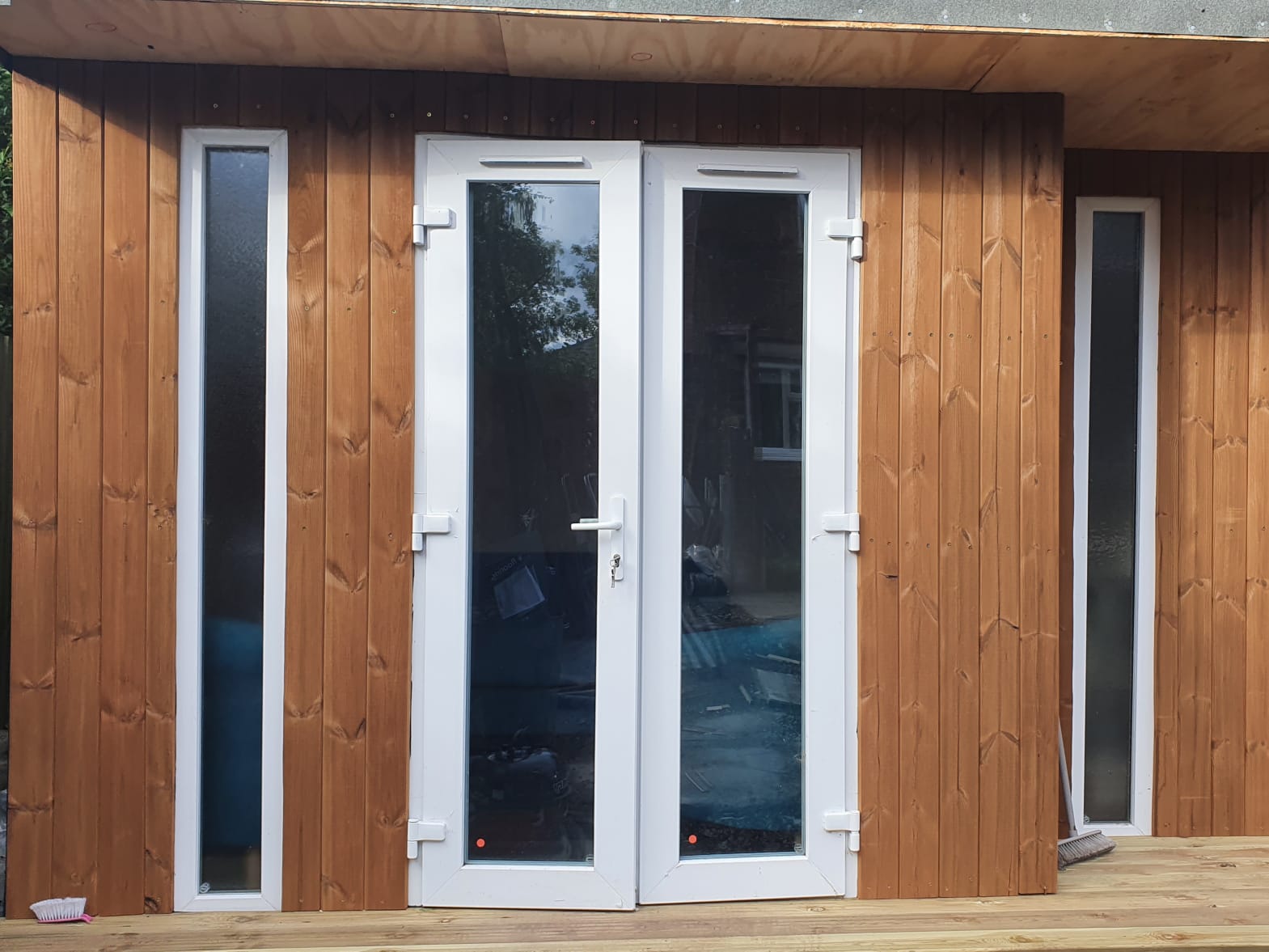 An outside view of the wooden office in Dawn's garden