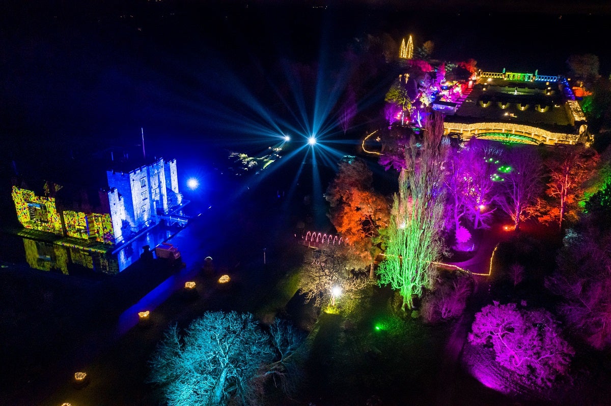 A birds-eye view of Hever Castle lit up by multi-coloured lights at Christmas 