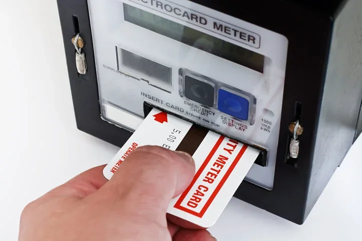 a business owner tops up a prepayment meter using a digital prepaid card credit