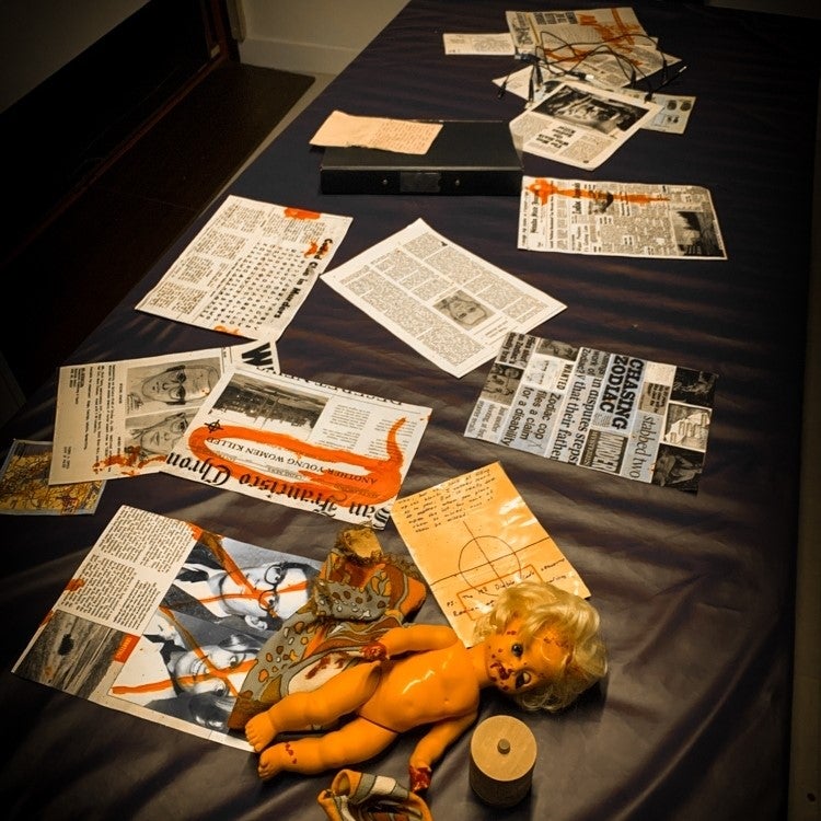 A pile of clues and newspaper clippings acting as some of the clues in one of the rooms
