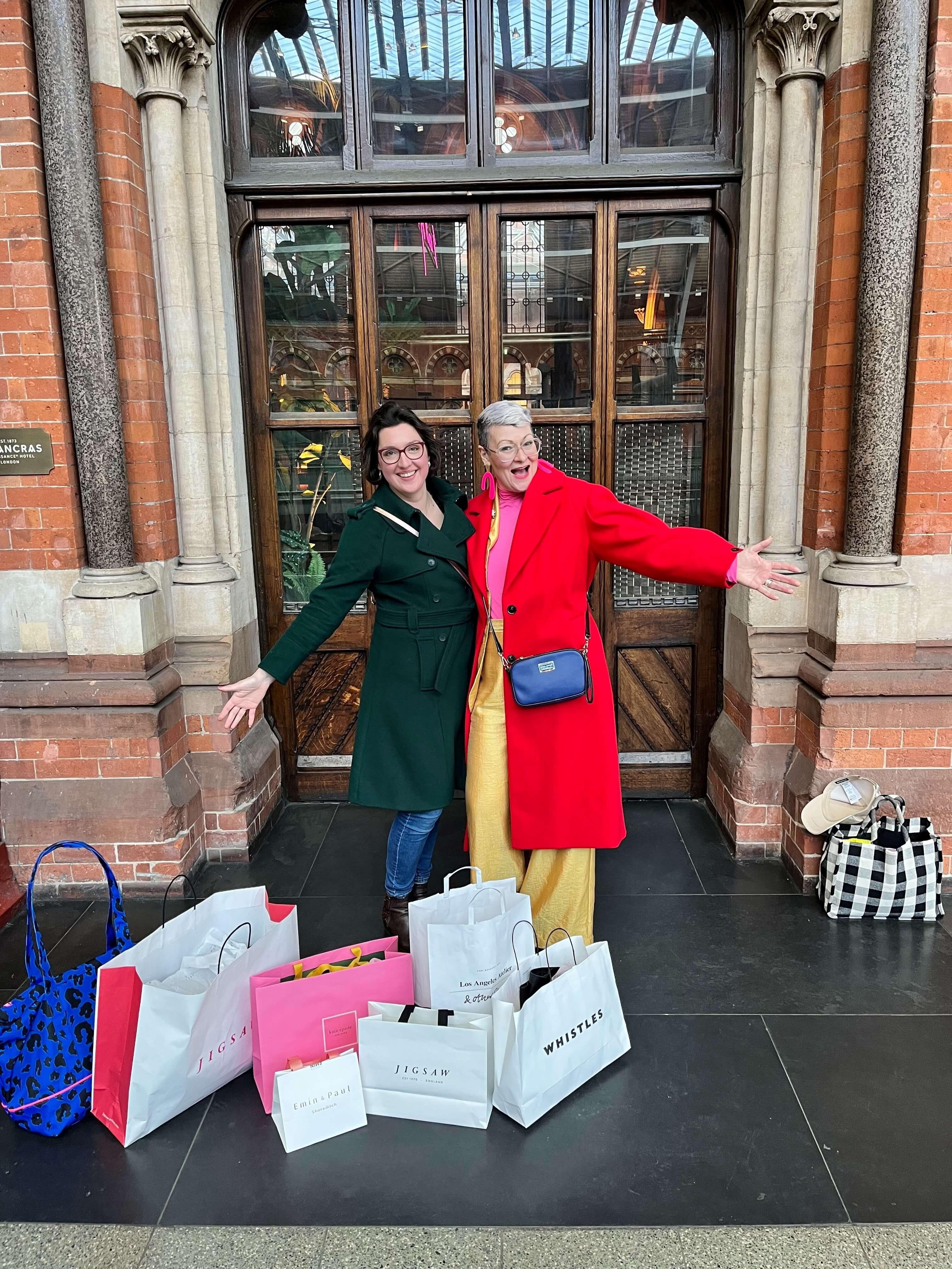 Abbey poses with a client and lots of shopping bags