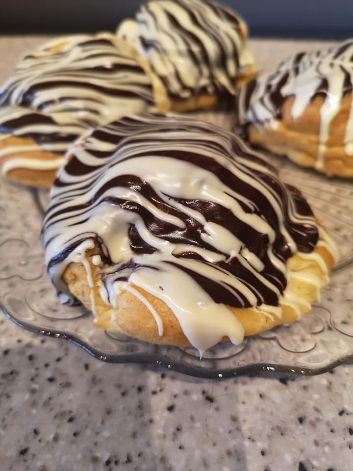 A pastry with white and brown striped icing 